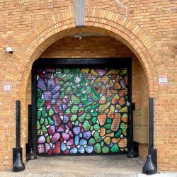 An art mural mimicking the train station's glass art across the street
